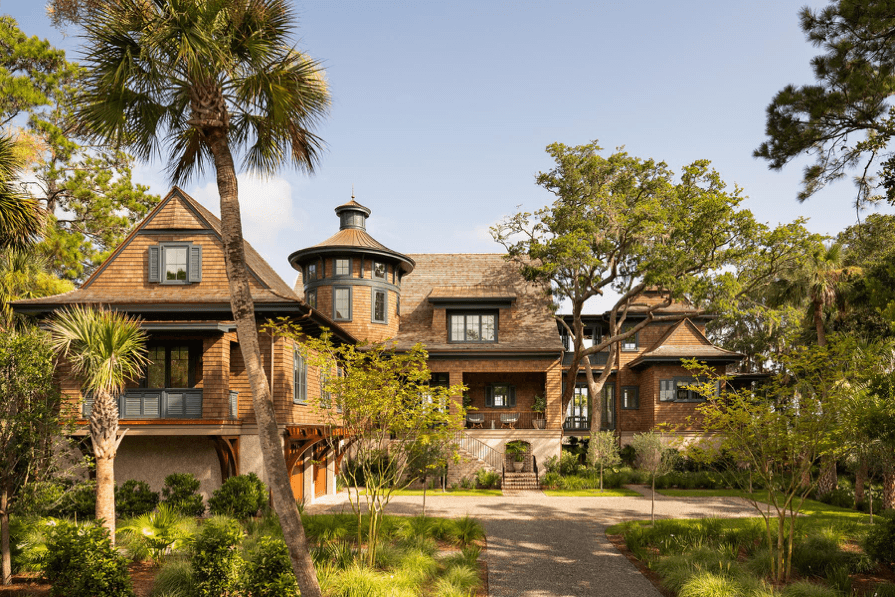 Luxury custom home exterior surrounded by mature trees